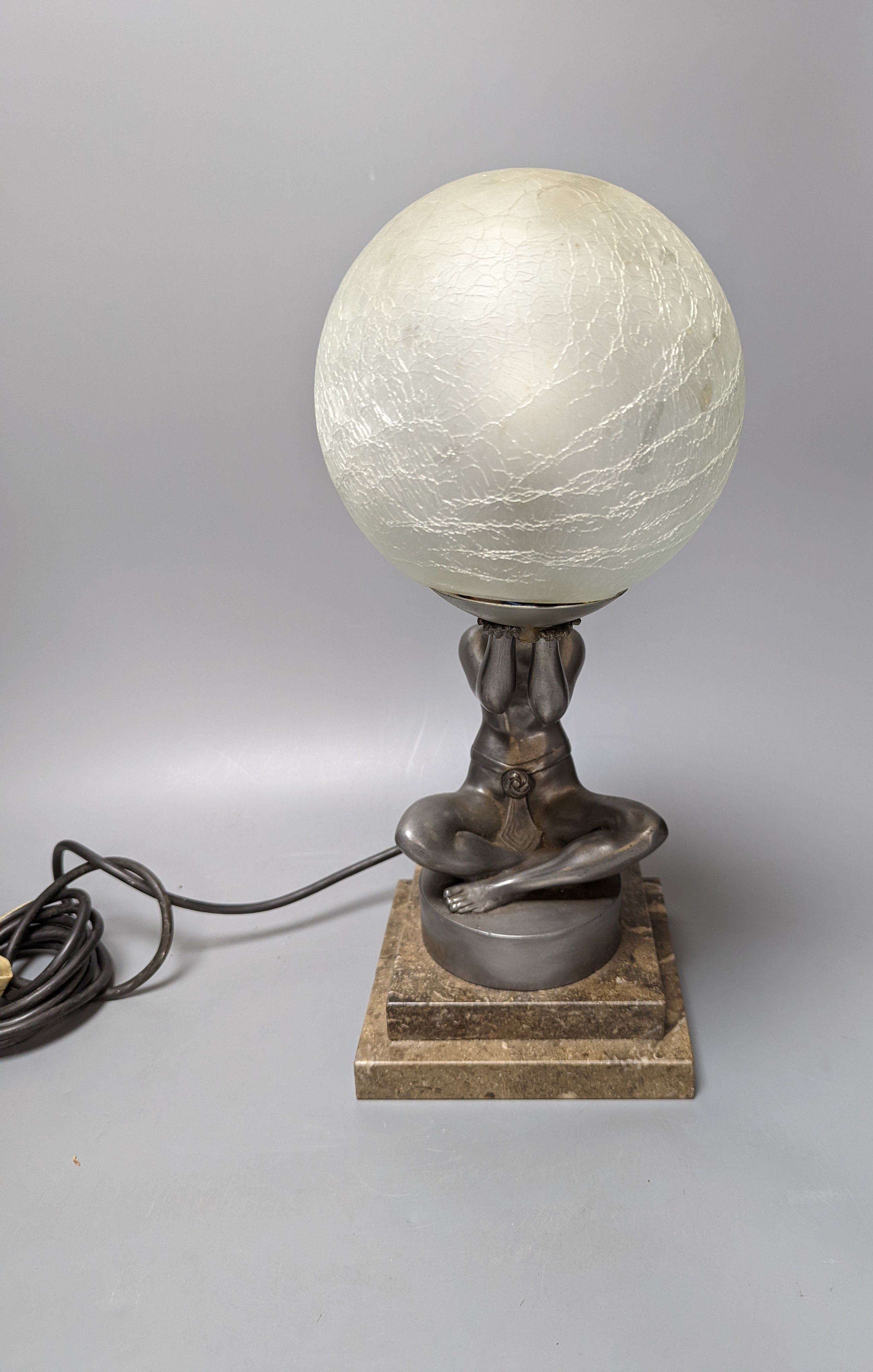 An Art Deco style ‘seated female’ lamp with spherical shade and marble base. 37cm